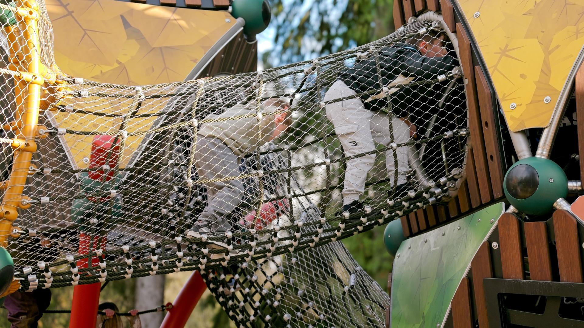 Rope tunnel on new adventure playground at Maple Ridge Park with 2 kids inside