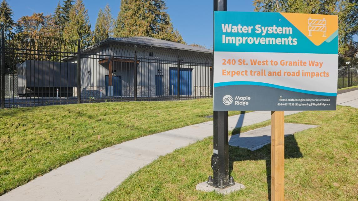 Front of pump station property featuring project sign