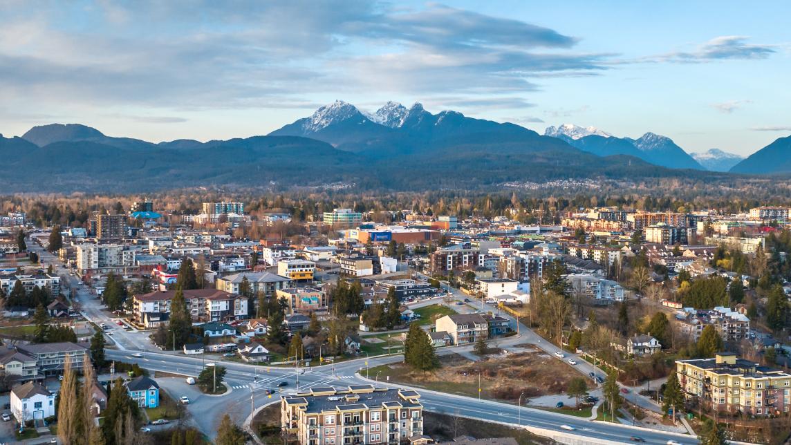 An aerial view of the Haney Bypass with the Golden Ears mountains in the background.