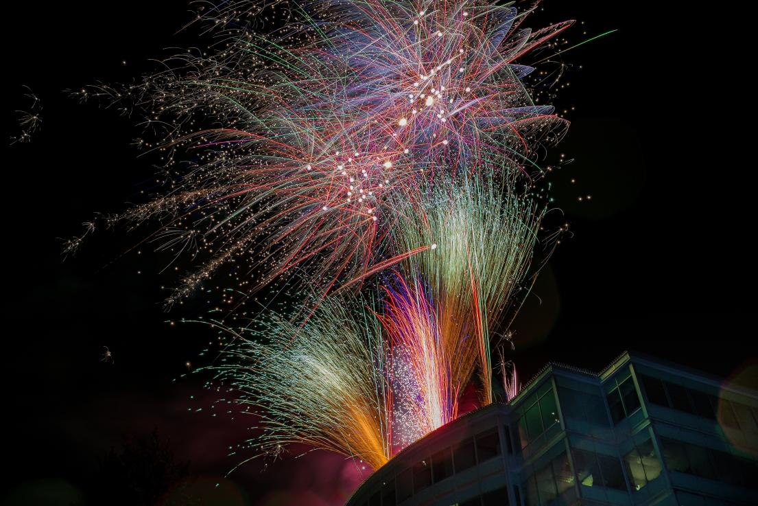 Colourful fireworks shoot upwards in streams from the roof of the Maple Ridge Business Centre tower and Library.