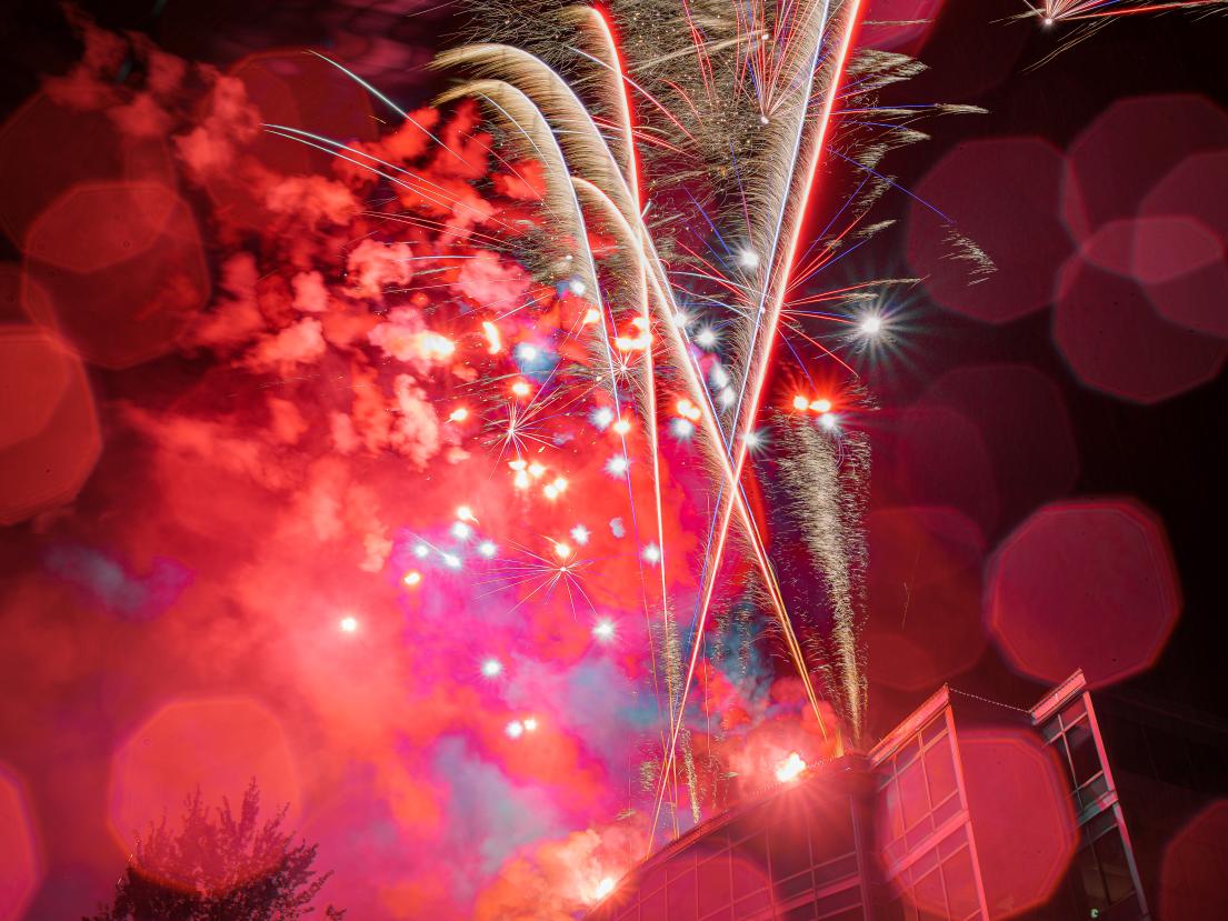 The red light of a firework refracts into octagons as it explodes.