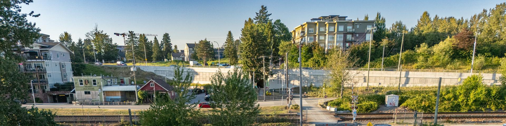 Buildings alongside the Haney Bypass next to the Port Haney Wharf from the view of the Fraser River.