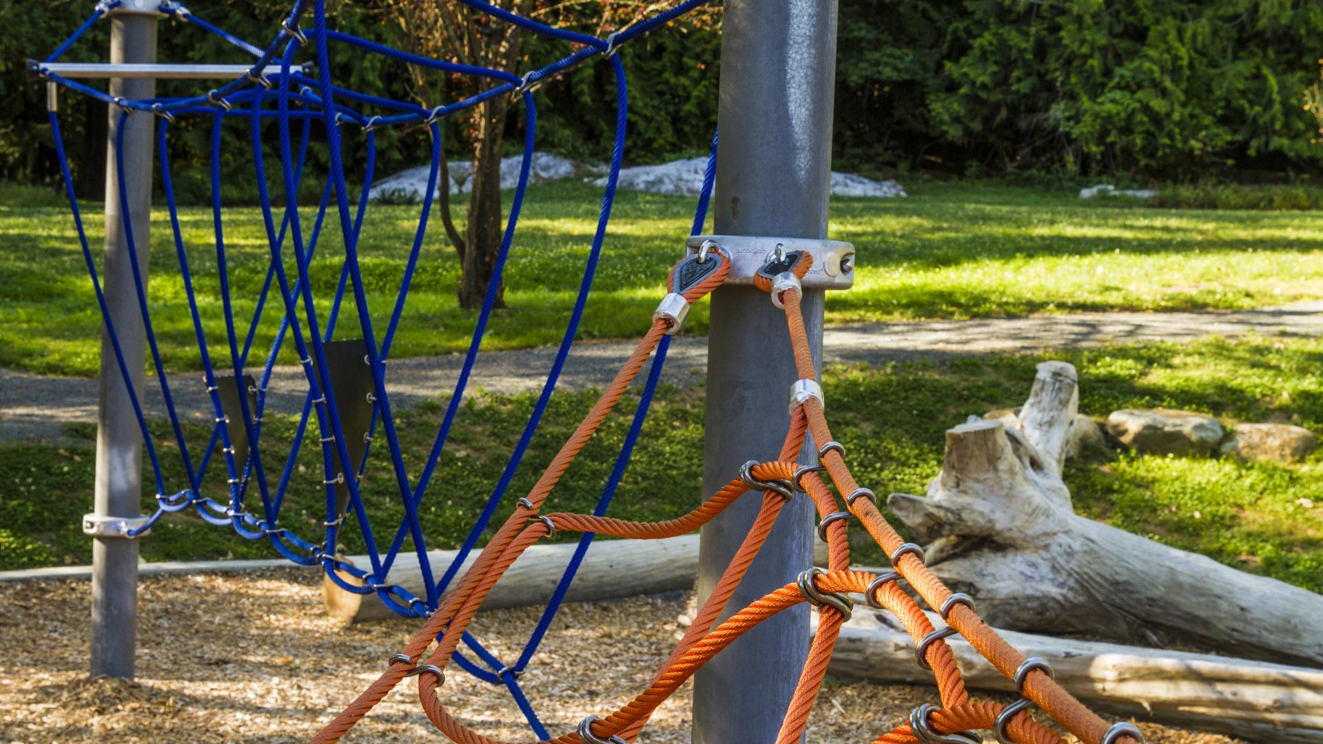 A closeup of how the rope climb is attached to the metal frame.