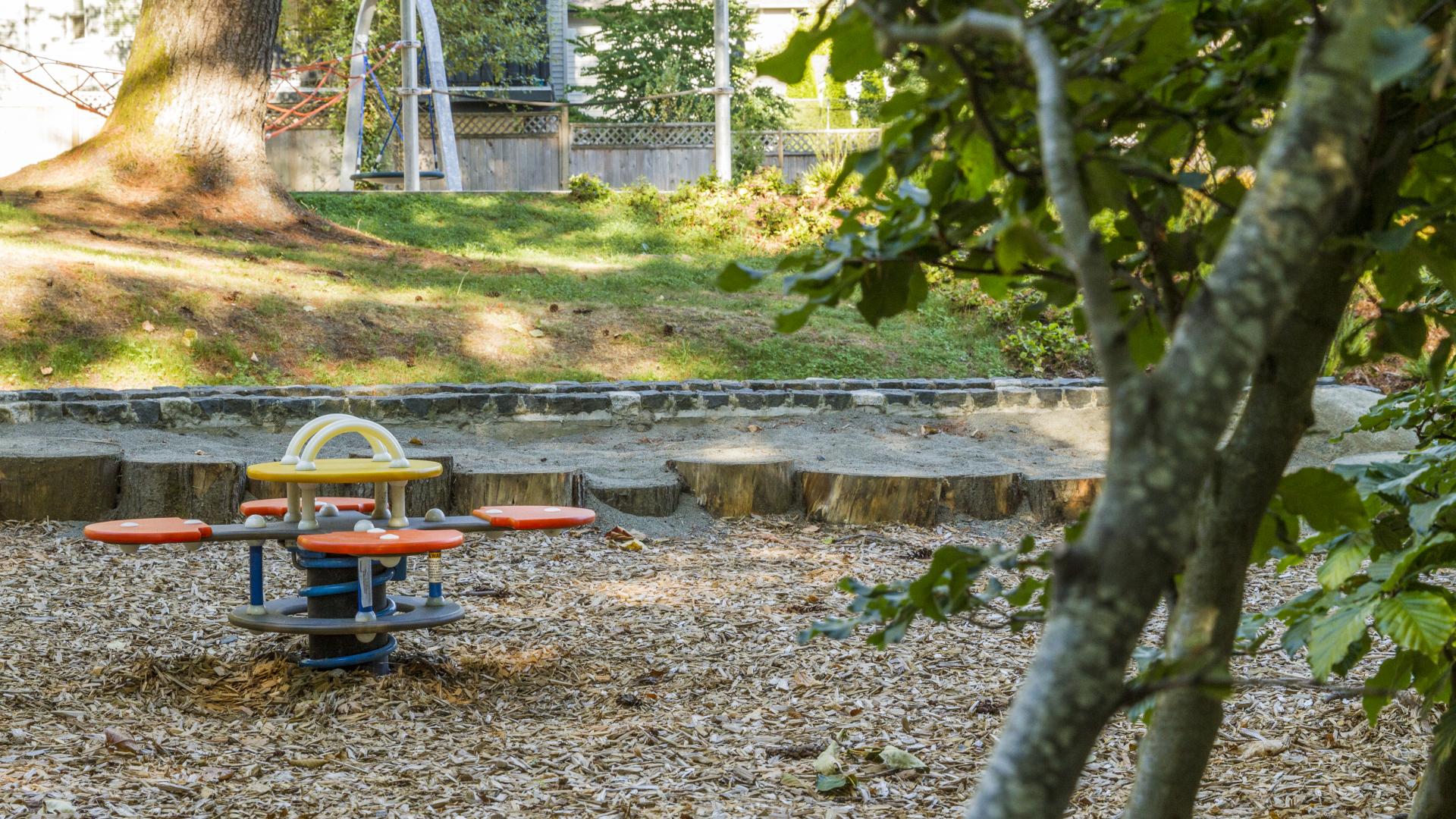 A four way seesaw on the playground mulch.