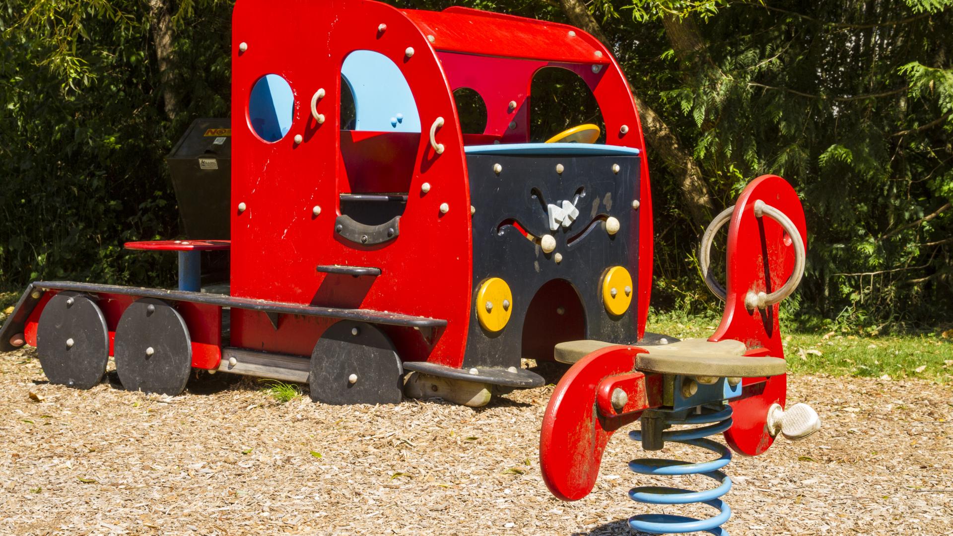 A red spring rider and a red truck shaped playground.