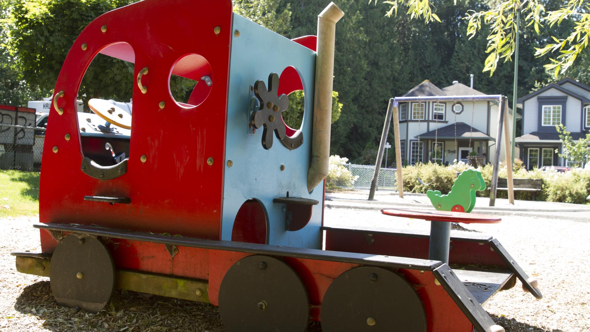 A red, truck shaped piece of playground equipment.