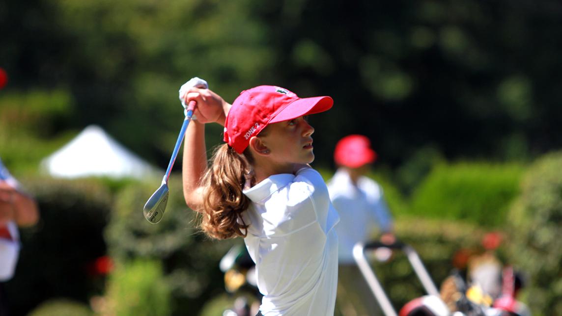 young girl playing golf