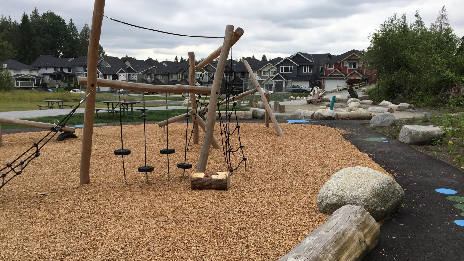 Log playground on woodchip surfacing with rope climbers and balance steppers