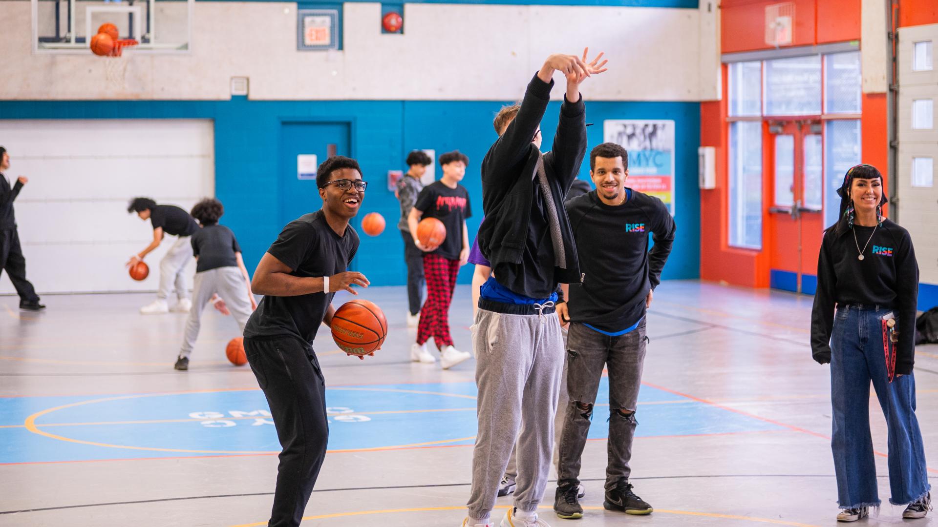 Group of Teens and Youth Staff Playing Basketball in the Greg Moore Youth Centre