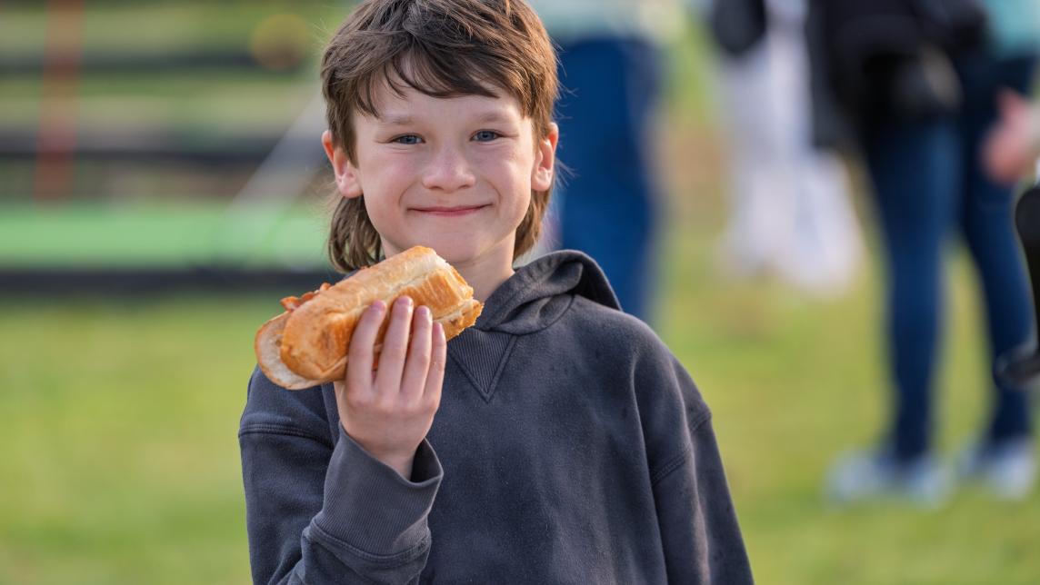 Young Boy Enjoying a Hotdog at Rock the Block at Volker Park