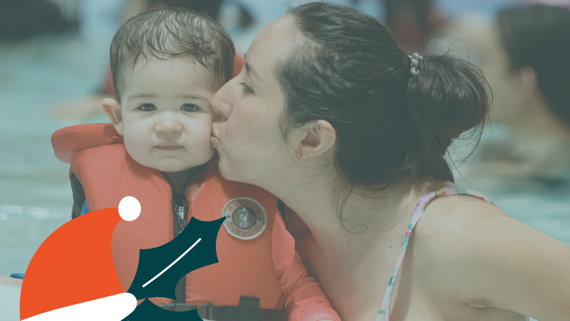 Little Boy in a Lifejacket with Parent in the Pool