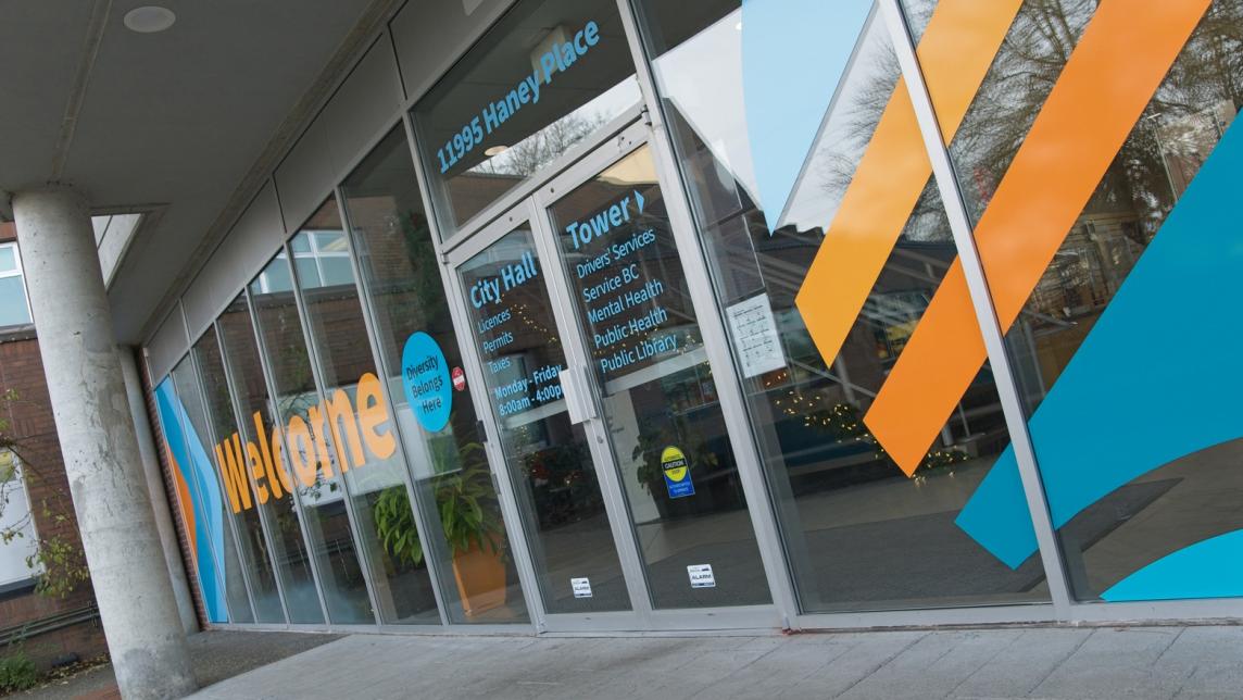 A close up of the new welcoming signage that greets people as they enter City Hall from Dewdney, showing which services are offered by the hall and which are located in the tower.
