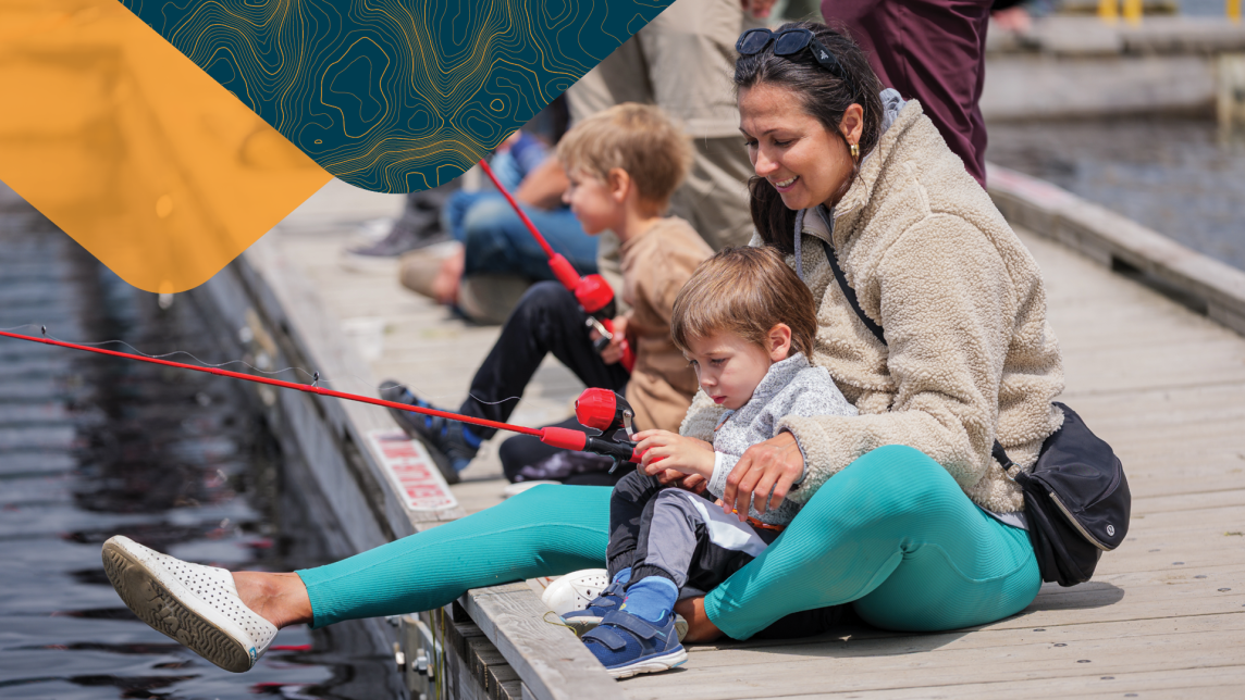 Family sitting on plank fishing
