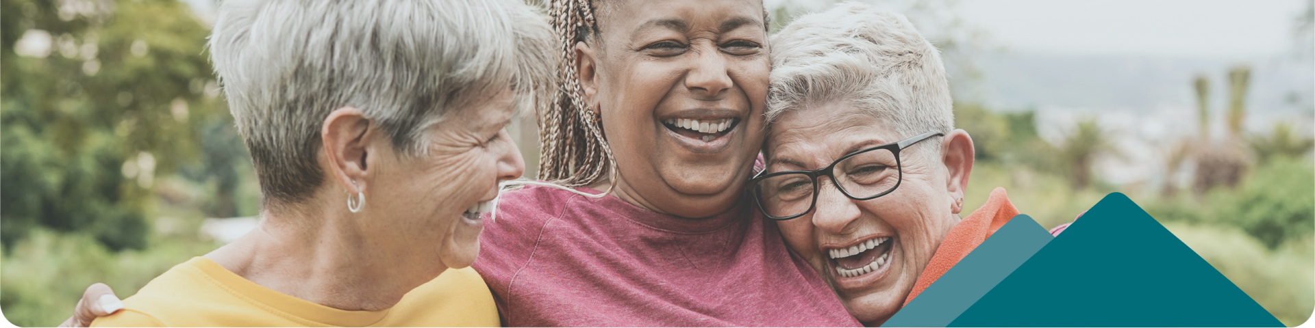 three senior women hugging