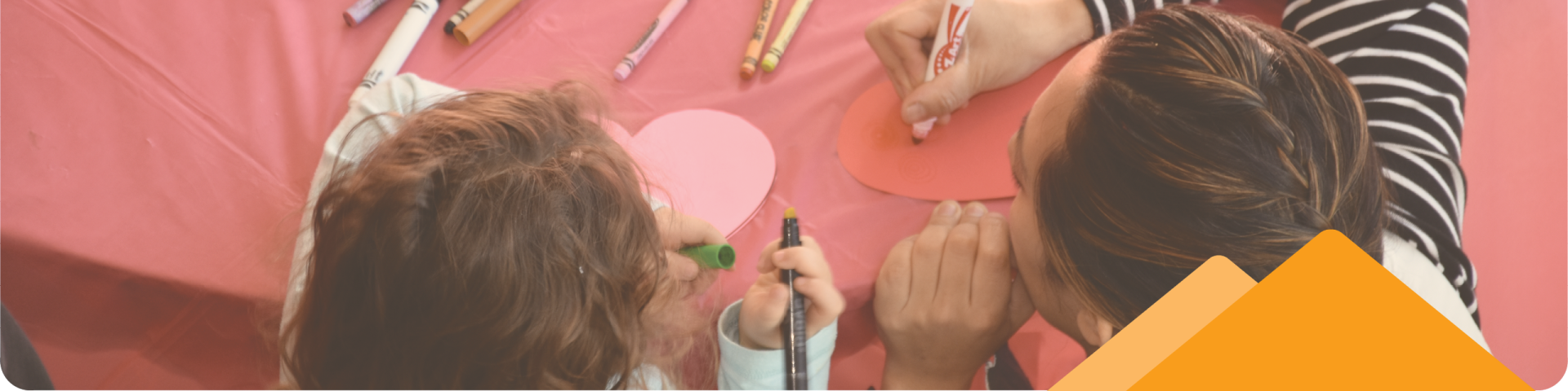 Mom and Child at a Table with Markers Doing Crafts