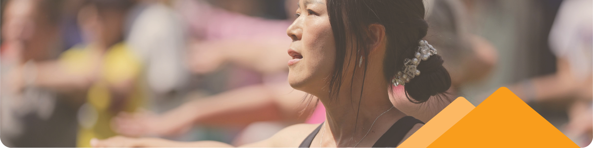 Woman in Group Working Out Outside in a Park