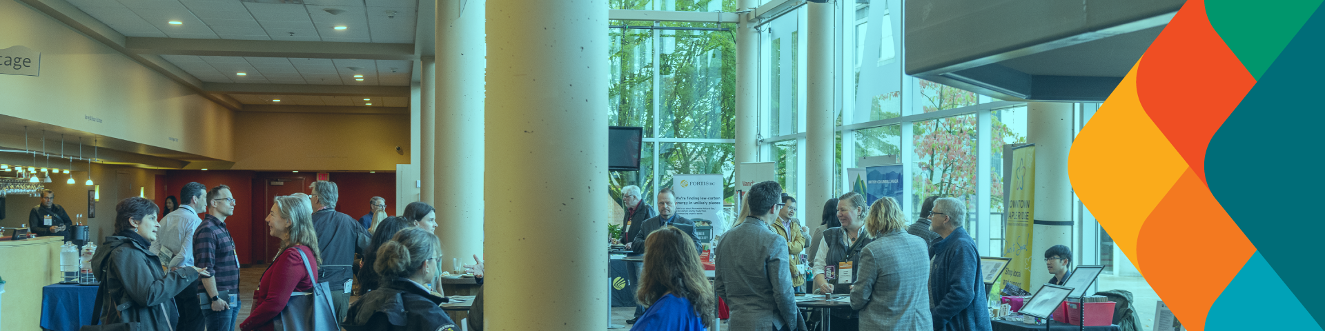 A large crowd gathers and talks in the lobby of the ACT Theatre.