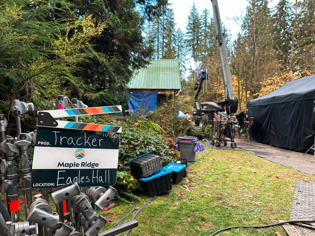 An exterior shot of "Tracker" filming at Eagles Hall with a Maple Ridge film slate in the foreground