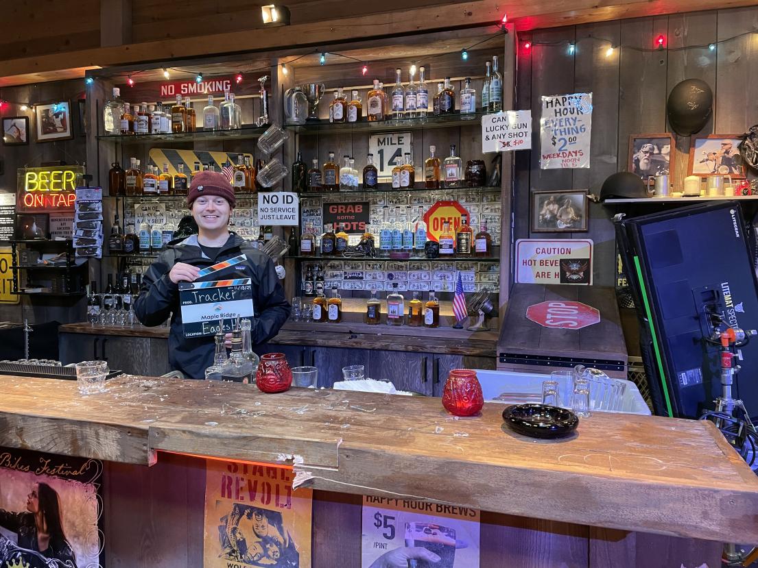 An interior shot of a person holding a Maple Ridge film slate on the set of "Tracker" at Eagles Hall