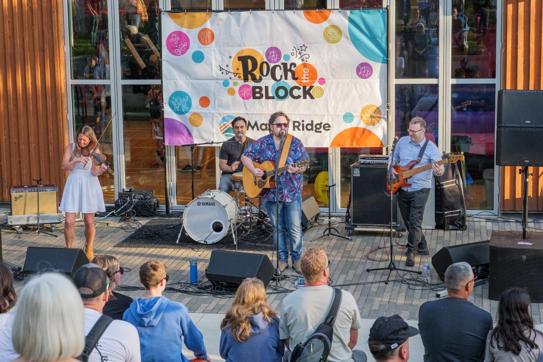 A Band Playing Outside at Rock the Block at Albion Community Centre