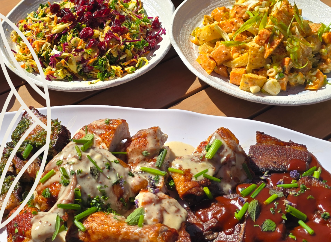 A dish full of meat with sauce topped sits next to a a dish of potatoes, both topped with green onions. A third dish of coleslaw topped with dried cranberries is nearby.