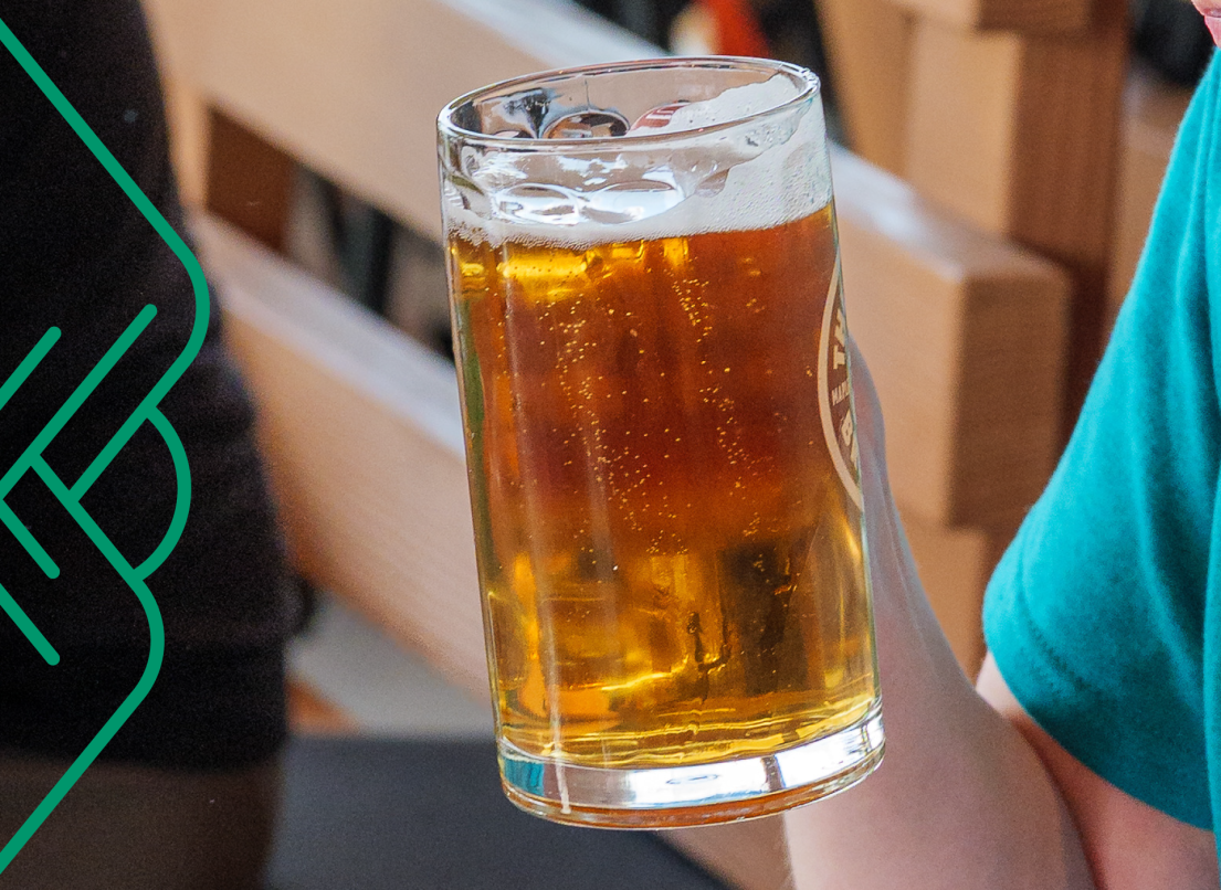 A waiter holds a tankard of beer.