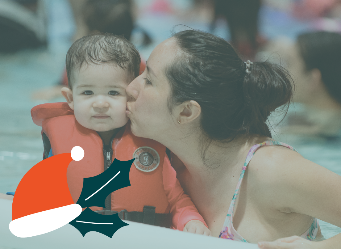Little Boy in a Lifejacket with Parent in the Pool