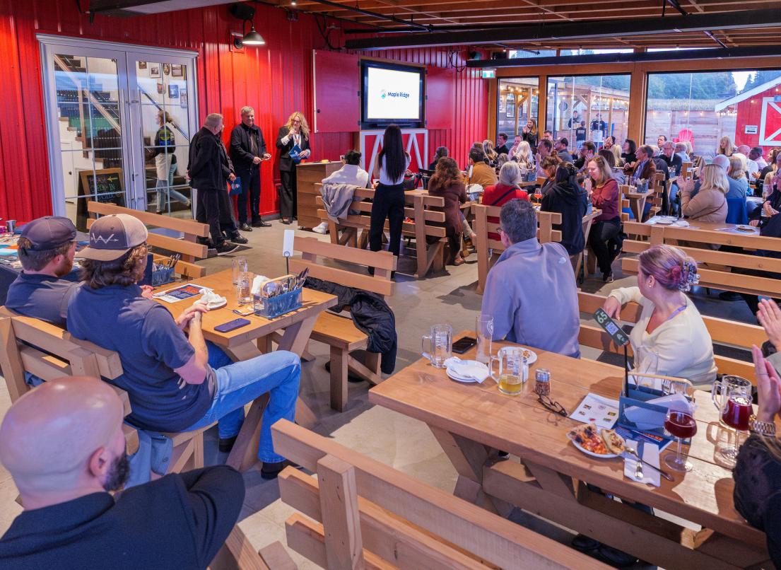 A crowd at the Patch Brewery watches presenters at the 2025 Innovation Challenge Awards event.