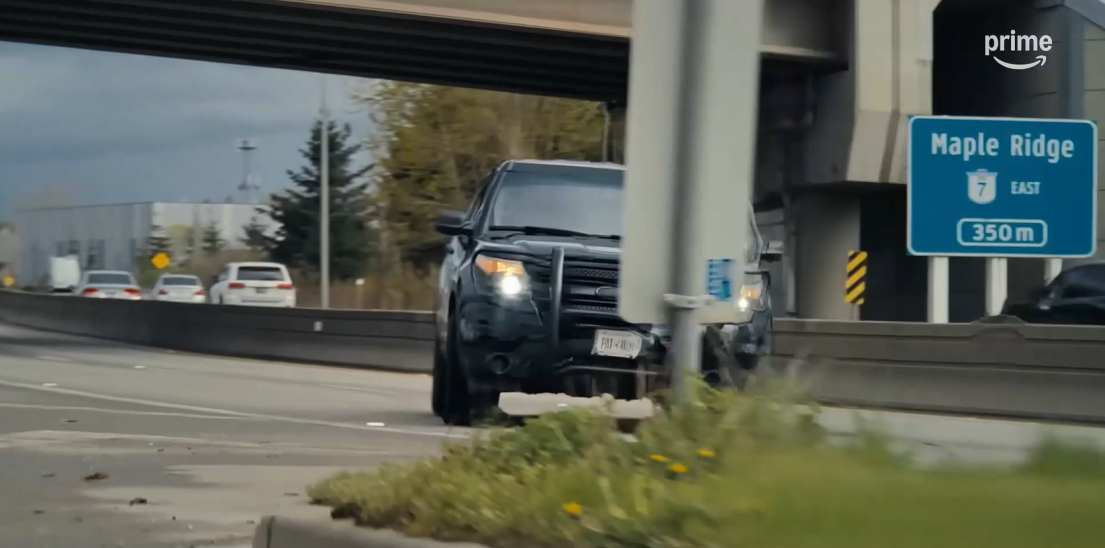 A black SUV driving along Maple Meadows Way in the film "Playdate"