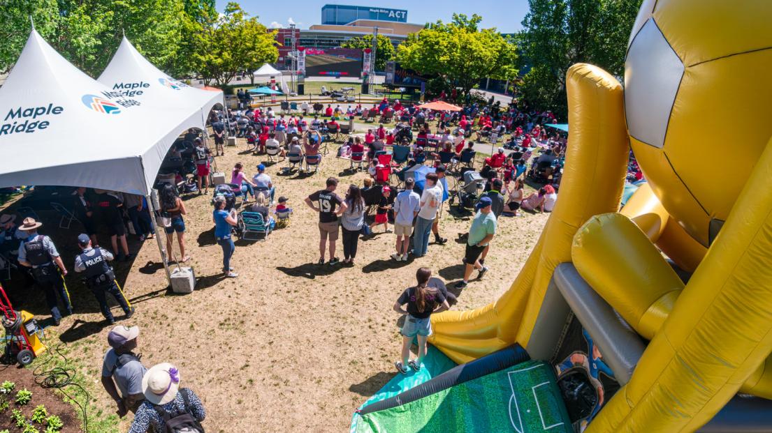 A giant trophy-shaped inflatable and two City-branded tents sit at the back of the Game On Viewing Party, overlooking the crowd.