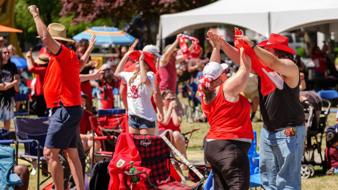 The crowd gives a standing ovation, arms high and some even dancing as a goal is scored at the Game On viewing party.