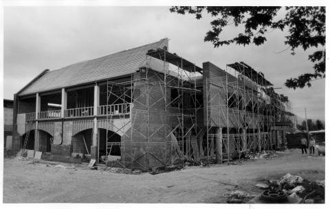 Municipal Hall under construction with scaffolding on exterior.