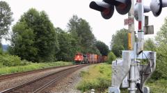 A train approaches a railroad crossing.