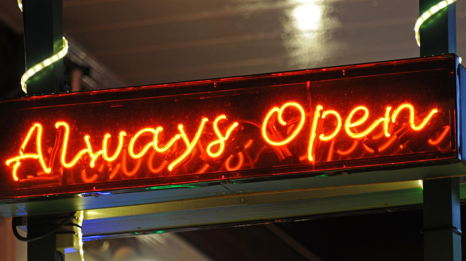 A bright neon red sign proclaiming "Always Open".