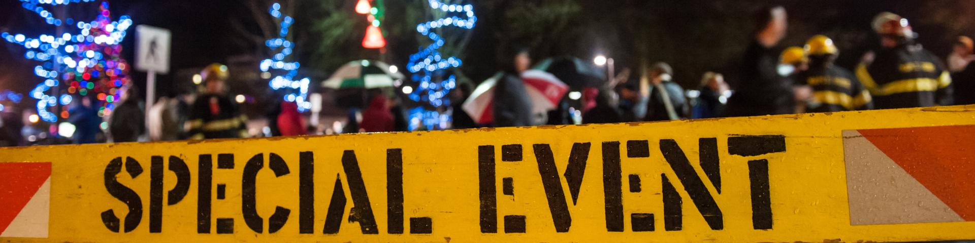 A crowd parades on the street behind a sign noting "Special Event".