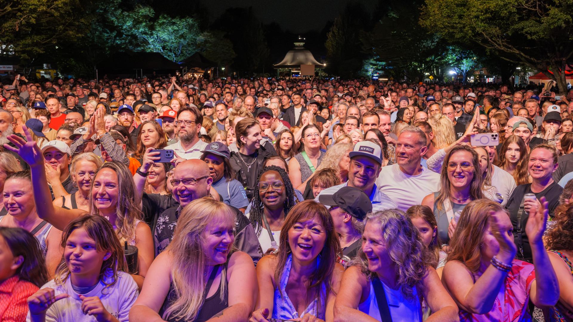 A large crowd gathers in Memorial Peace Park at the 2025 Our Neck of the Woods festival.