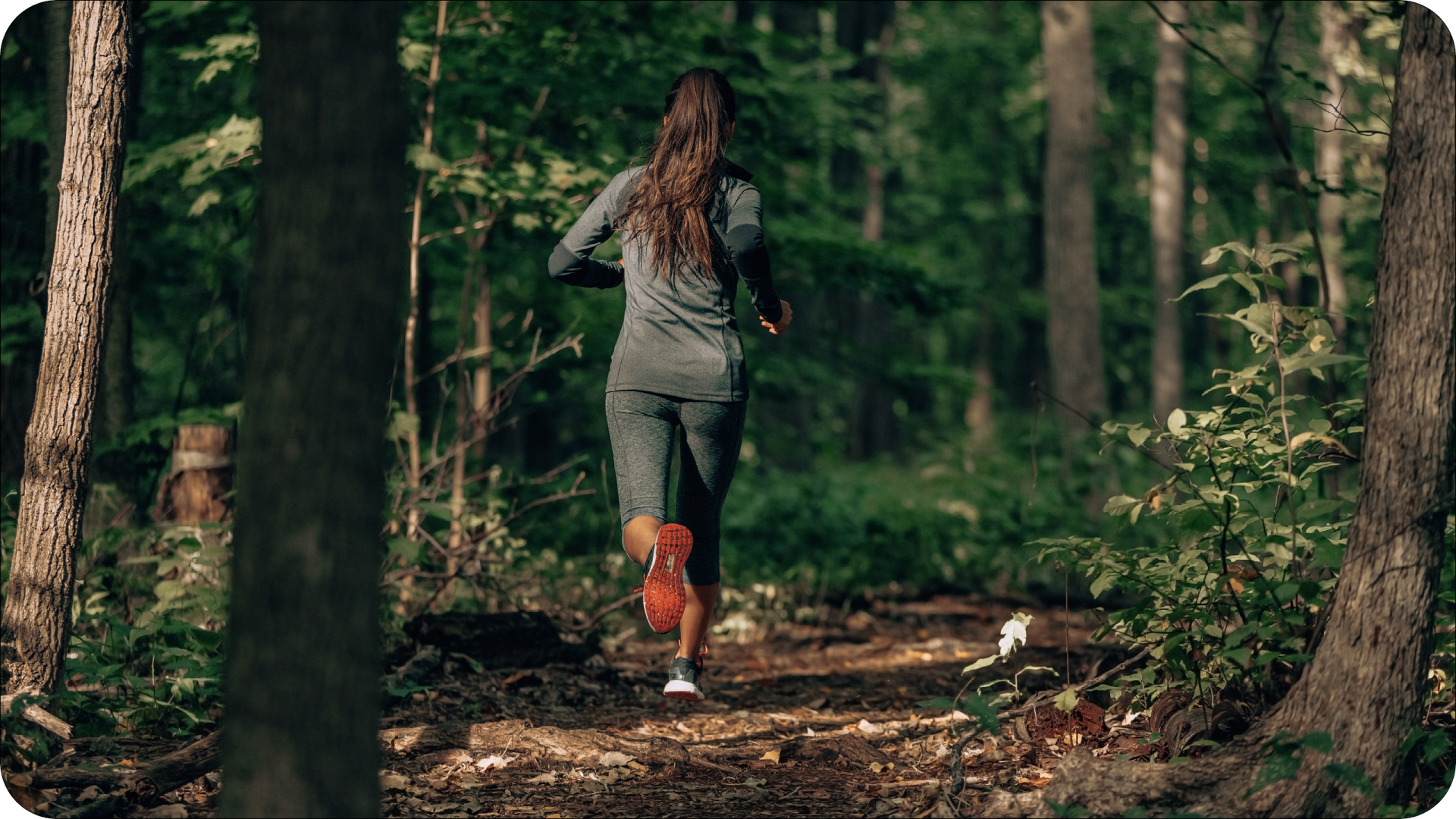 Woman Running on a Forest Trail